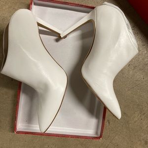 White heels, back out sleek and say shoes